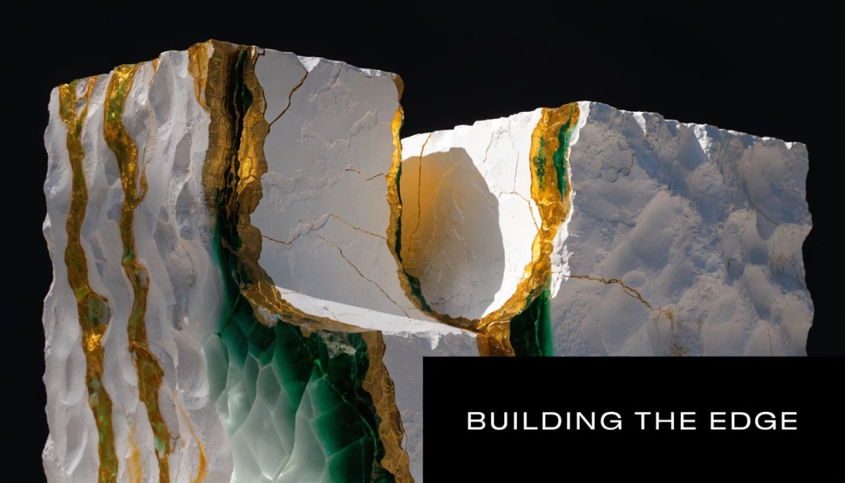 A close up artistic sculpture of white stone blocks featuring vibrant green and golden cracked edges.